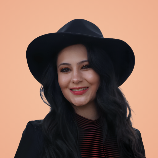 Lauren Medina, licensed therapist, smiling warmly in a black wide-brim hat